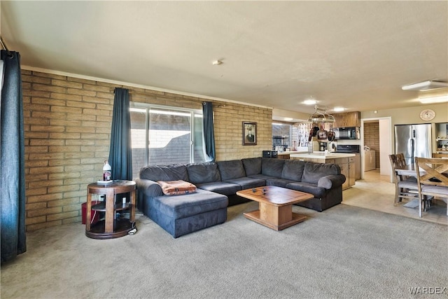 living room with light carpet and brick wall