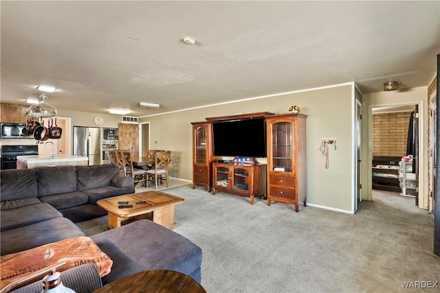 living room with baseboards, visible vents, and light colored carpet