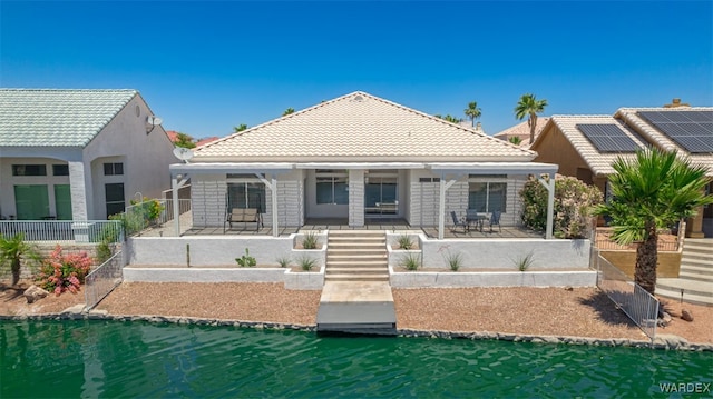 2044 E Los Lagos Dr, Fort Mohave, AZ 86426 - back of house featuring a tiled roof and covered porch