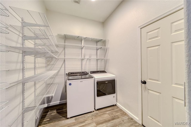 2044 E Los Lagos Dr, Fort Mohave, AZ 86426 - washroom with washer and clothes dryer and light wood-type flooring
