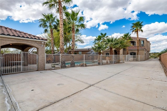 exterior space featuring fence and a community pool