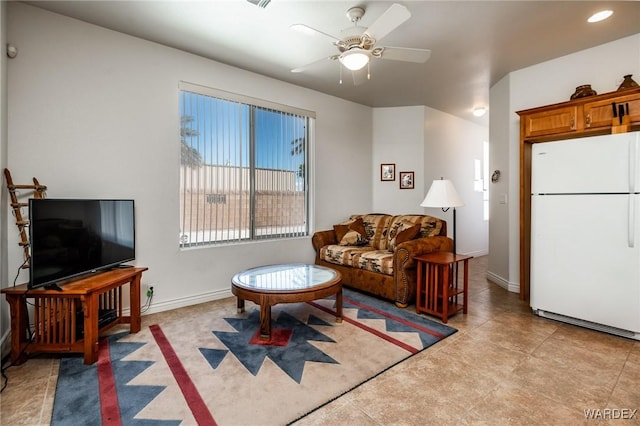 living room featuring ceiling fan, recessed lighting, and baseboards