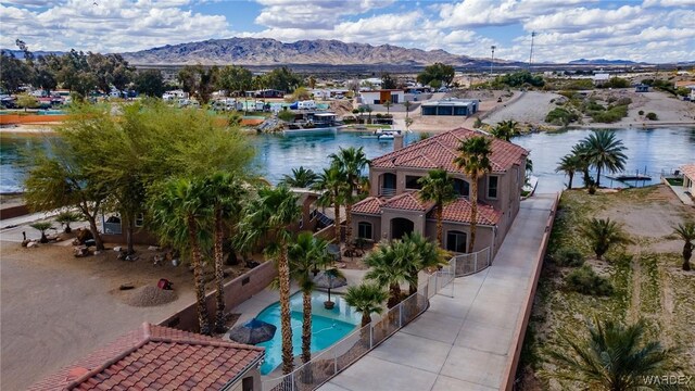 exterior space with a fenced in pool and a water and mountain view