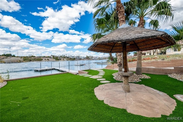 view of yard featuring a water view and a floating dock