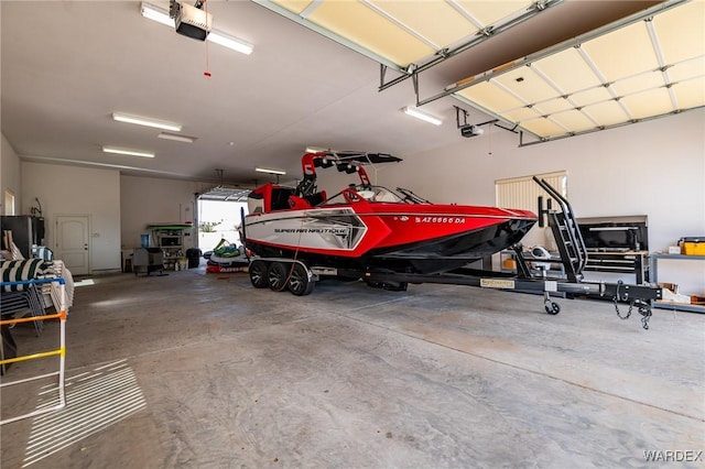 garage featuring a garage door opener and freestanding refrigerator