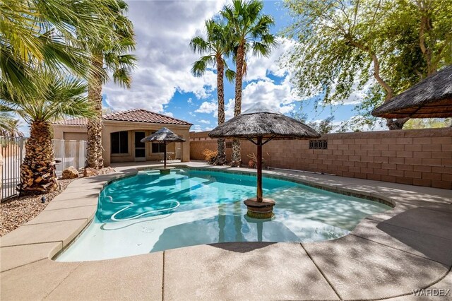 view of pool featuring a patio area, a fenced backyard, a fenced in pool, and a gazebo