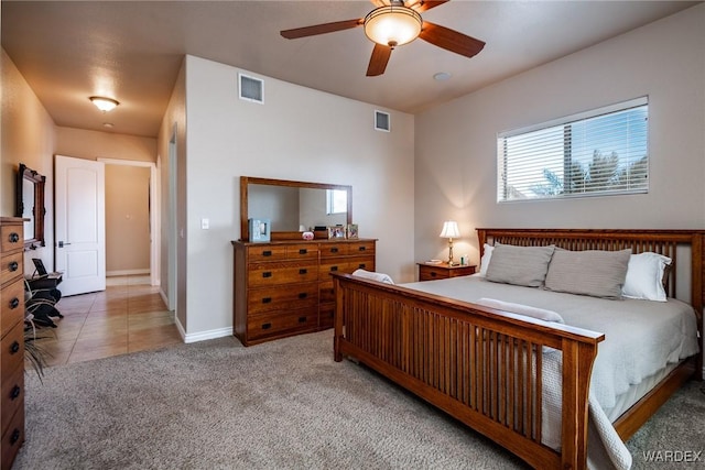 tiled bedroom featuring carpet, visible vents, ceiling fan, and baseboards