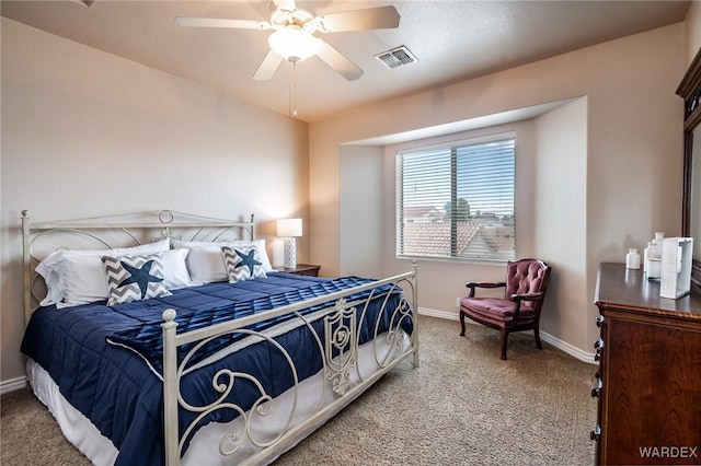 carpeted bedroom with a ceiling fan, visible vents, and baseboards