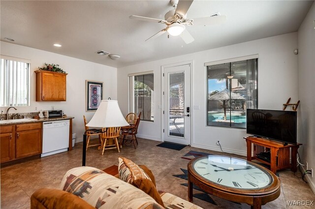 living room with baseboards, visible vents, and a ceiling fan