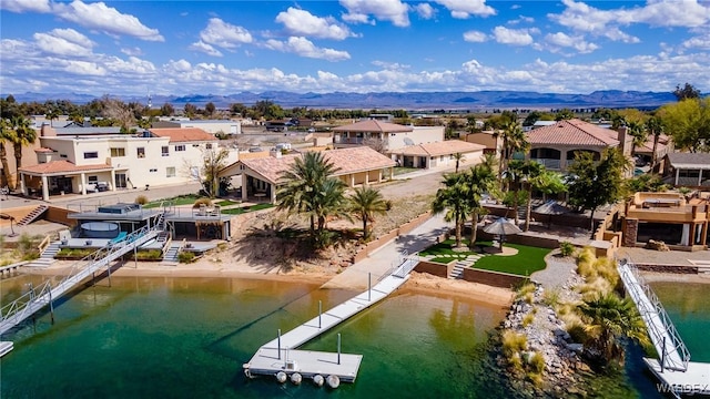 aerial view featuring a residential view and a water and mountain view