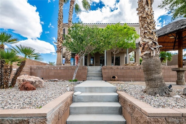 view of front of house featuring a fenced front yard and stucco siding