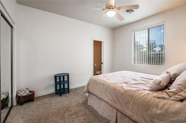 carpeted bedroom with ceiling fan, a closet, visible vents, and baseboards