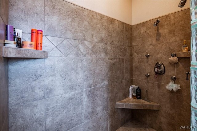 full bath with a tile shower