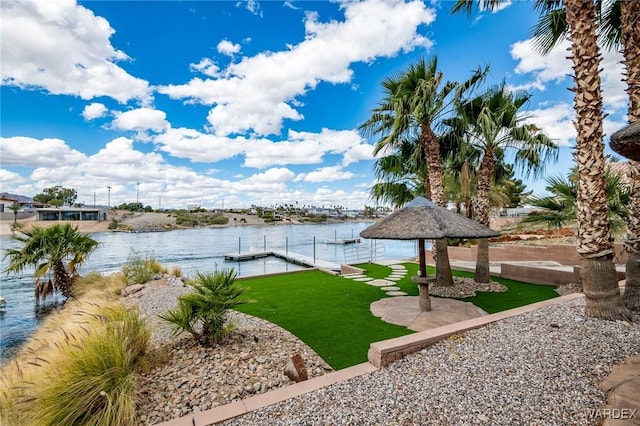 exterior space with a water view and a yard