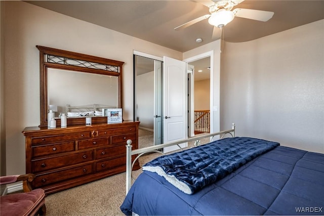 bedroom with ceiling fan, a closet, and light colored carpet