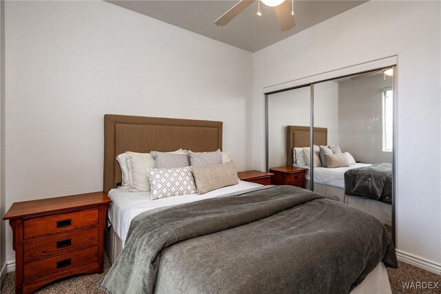 carpeted bedroom with a closet and a ceiling fan