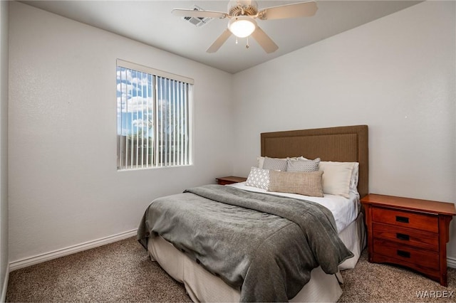 carpeted bedroom with ceiling fan and baseboards