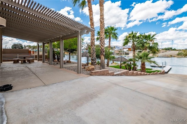 view of patio with a water view and a pergola