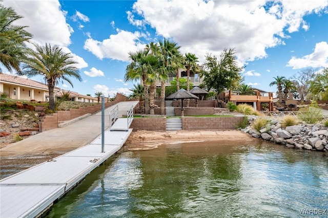 view of dock featuring a water view and a gazebo