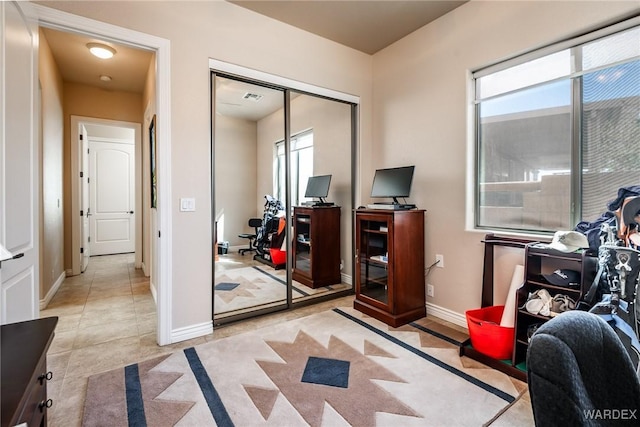 office area featuring light tile patterned flooring and baseboards