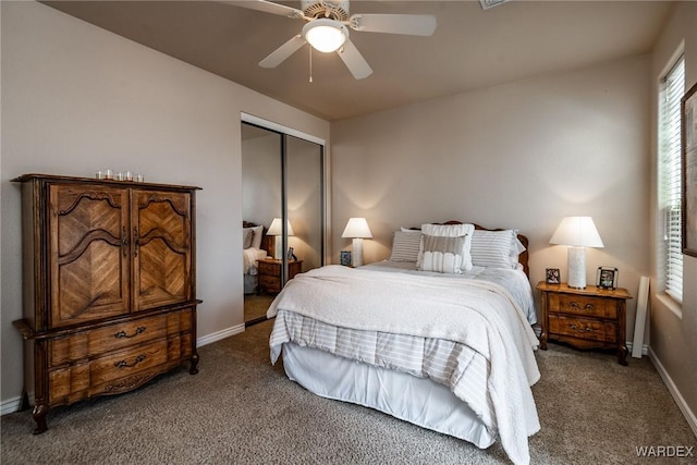 bedroom featuring carpet, baseboards, ceiling fan, and a closet