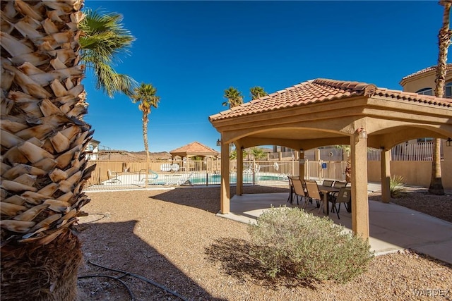 exterior space with a patio, a swimming pool, and fence