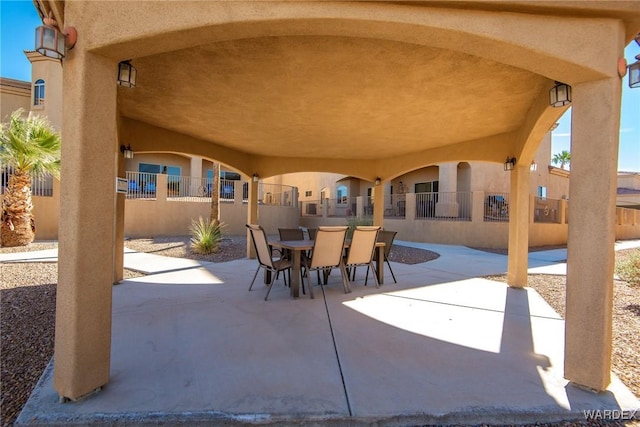 view of patio featuring outdoor dining area and fence