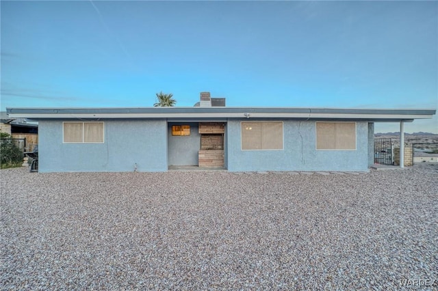 rear view of property with stucco siding