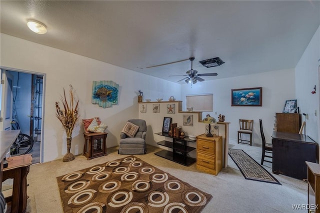 living area featuring ceiling fan and carpet flooring