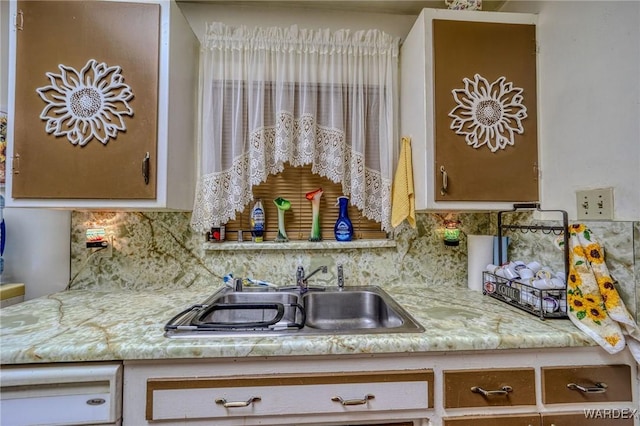 kitchen with tasteful backsplash and a sink