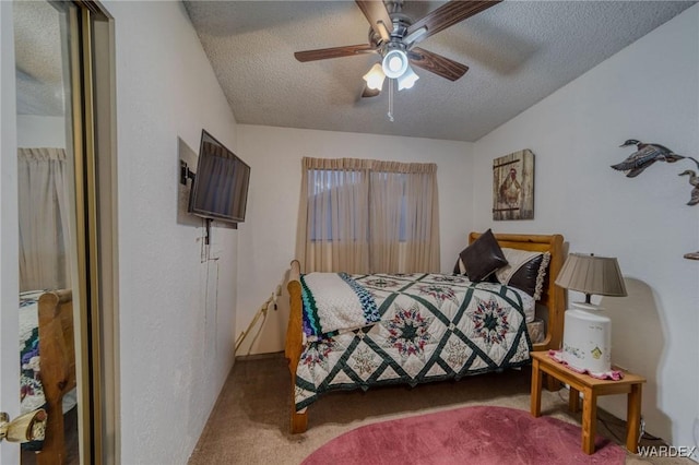 bedroom featuring carpet floors, ceiling fan, and a textured ceiling