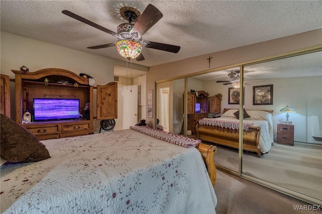 bedroom featuring carpet, a closet, ceiling fan, and a textured ceiling