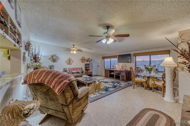 living area featuring a textured ceiling and a ceiling fan