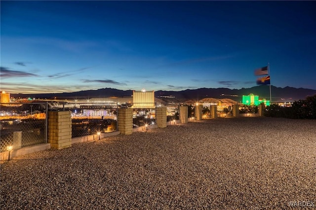 yard at dusk featuring a mountain view