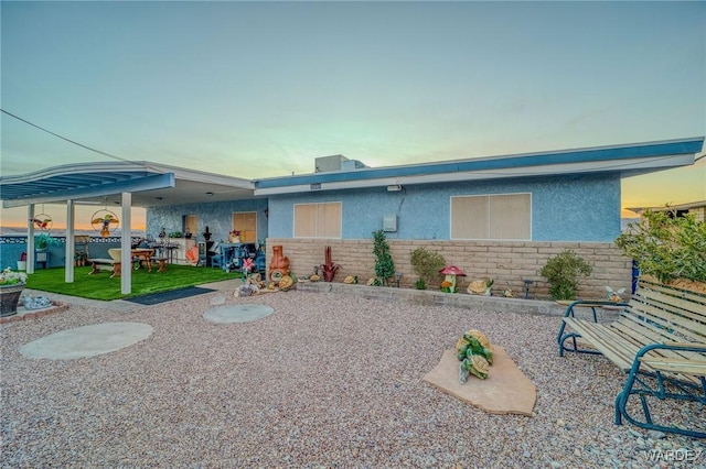 view of front of property with stone siding and stucco siding