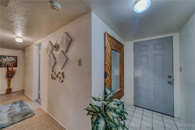 foyer with a textured ceiling