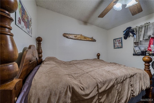 bedroom featuring a textured ceiling, ceiling fan, and vaulted ceiling