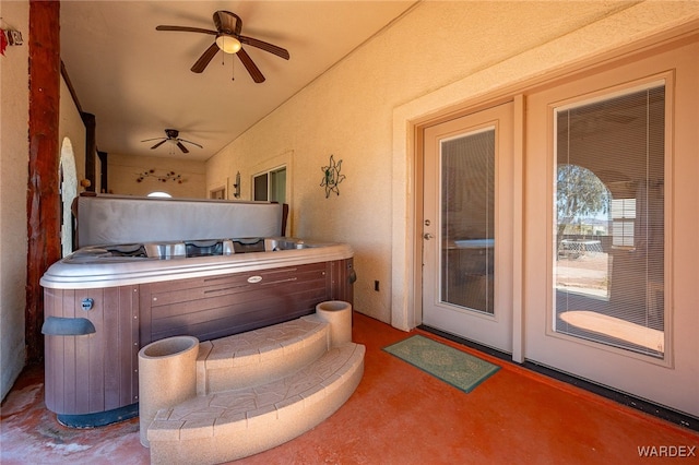 view of patio / terrace with ceiling fan and a hot tub