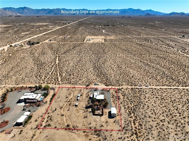 bird's eye view featuring a desert view, a mountain view, and a rural view