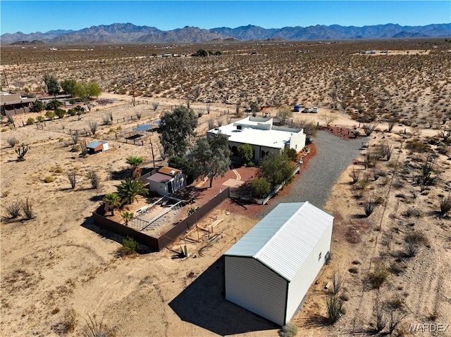 bird's eye view featuring a mountain view, a desert view, and a rural view