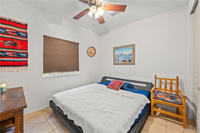 bedroom featuring light tile patterned floors, a ceiling fan, and baseboards