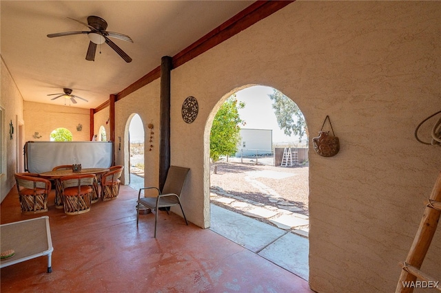 view of patio with outdoor dining space and a ceiling fan