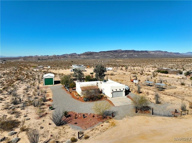 bird's eye view with a mountain view, a rural view, and view of desert