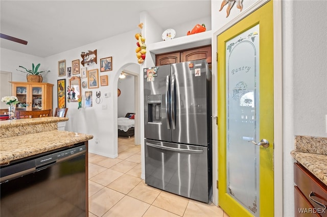 kitchen with black dishwasher, arched walkways, light tile patterned flooring, stainless steel fridge with ice dispenser, and ceiling fan