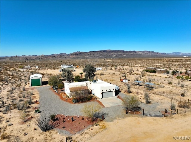 aerial view with a mountain view, a desert view, and a rural view