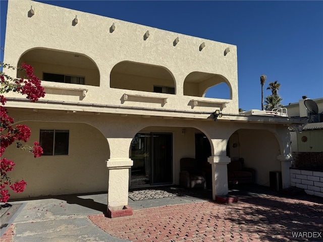 view of front of property featuring stucco siding and a patio