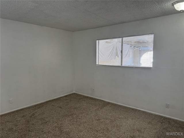 unfurnished room with dark carpet, a textured ceiling, and baseboards