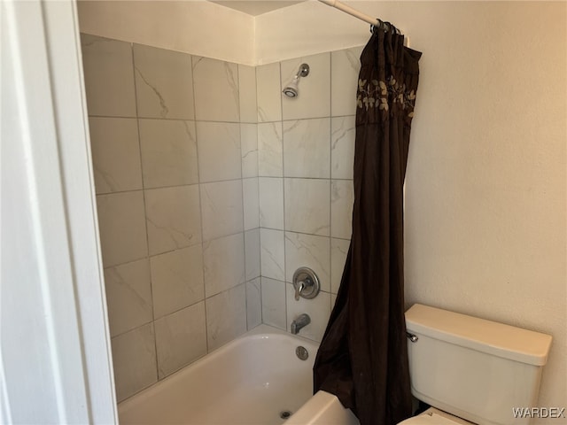 bathroom with shower / tub combo and toilet