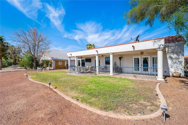 1878 E Fairway Bnd, Fort Mohave, AZ 86426 - rear view of property featuring a ceiling fan, french doors, a yard, stucco siding, and a patio area