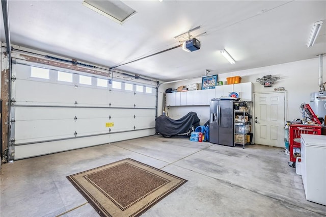 1878 E Fairway Bnd, Fort Mohave, AZ 86426 - garage with stainless steel refrigerator with ice dispenser and a garage door opener